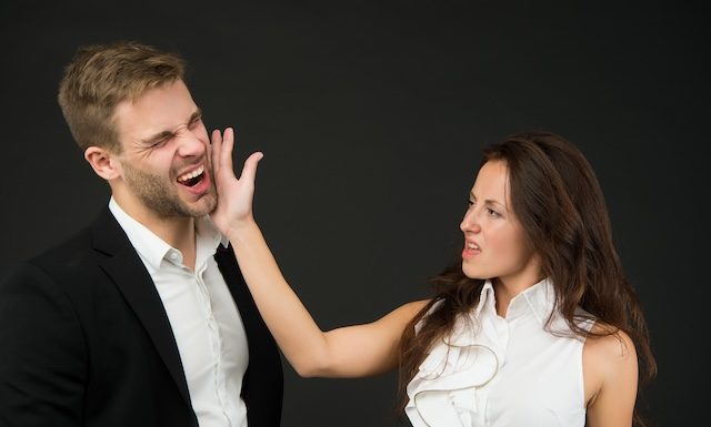 Abuse at work. Angry woman slap man in face. Using physical abuse in workplace. Physical harm. Coworker harassment and discrimination. Bullying and violence. Occupational injury. Victim protection