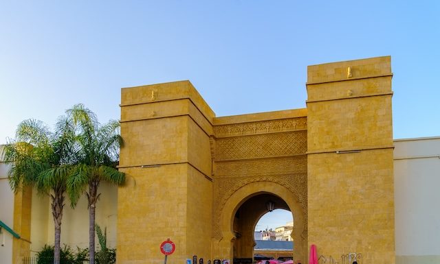 Casablanca, Morocco - March 29, 2023: Street view with Bab lakir gate, locals, and visitors, in Casablanca, Morocco
