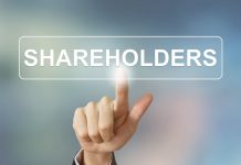 Économie | Christian Louboutin, actionnaire « Experimental Group » business hand pushing shareholders button on blurred background