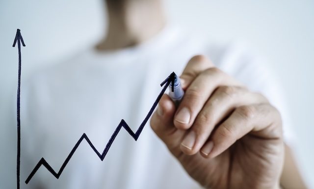 Business growth sale concept. Hand draws a graph of economic profit growth and development