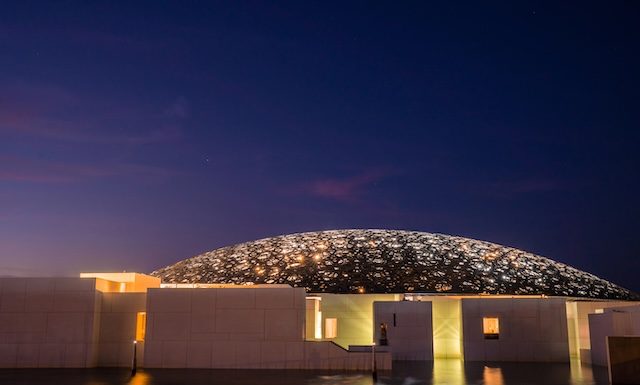 Louvre, Abu Dhabi, United Arab Emirates - May 10, 2020. The famous Louvre museum of the French architect Jean Nouvel - panoramic view from the tribune at night.