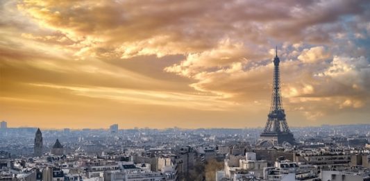 Paris, beautiful Haussmann facades and roofs in a luxury area of the capital, view from the triumph arch, with the Eiffel Tower