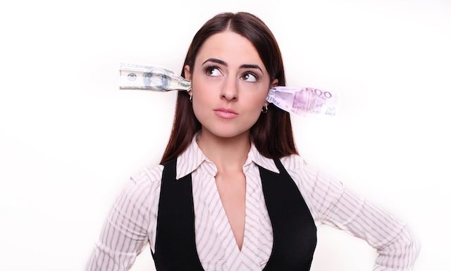 Corruption. It will keep me quiet. Bribery concept in politics, business, diplomacy. Corporate businesswoman plugs her ears with dollar banknotes, bills, covers her mouth, isolated white background