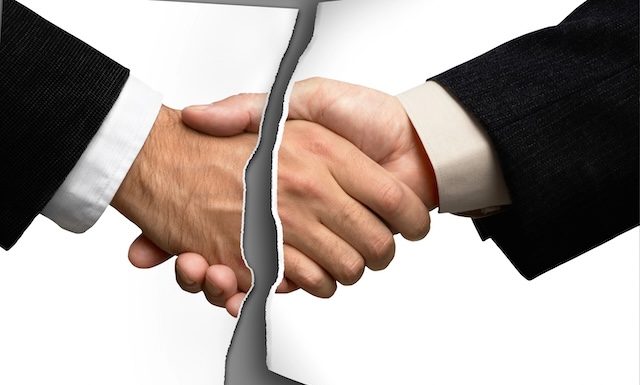 Two businessmen shaking hands @ credit depositphotos.com
