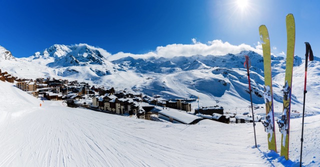 Ski in winter season, view from ski run at mountains and Val Thorens resort in sunny day in France, Alps.