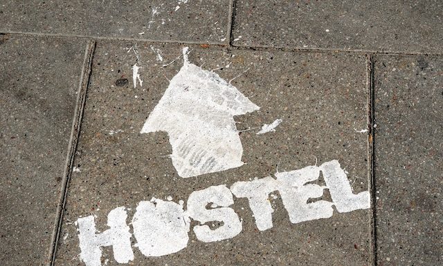 hostel sign with arrow showing direction