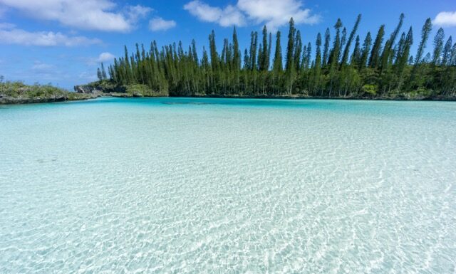 beautiful seascape of natural swimming pool of Oro Bay, Isle of Pines, New Caledonia. aquamarine translucent water.