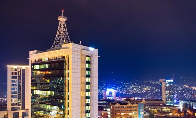Kigali, Rwanda - August 17 2022: Kigali city centre lit up at night with Pension Plaza, City Tower and other buildings in view.