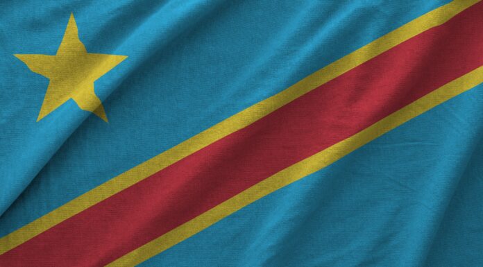 Democratic Republic of the Congo flag depicted on folded wavy fabric of old cloth close up