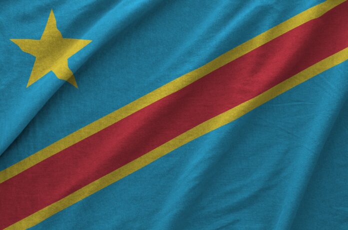 Democratic Republic of the Congo flag depicted on folded wavy fabric of old cloth close up