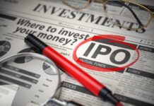 IPO* & résilience | Ennismore, 200 hôtels, une gouvernance réformée et une guerre qui change tout IPO Initial public offering concept. Where to Invest concept, Investments newspaper with loupe and marker.