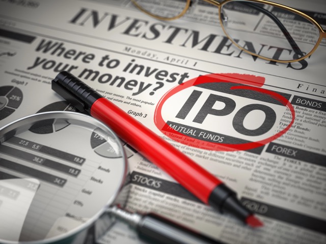 IPO Initial public offering concept. Where to Invest concept, Investments newspaper with loupe and marker.