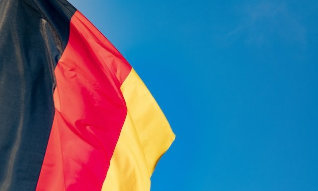 detail of german flag under clear blue sky