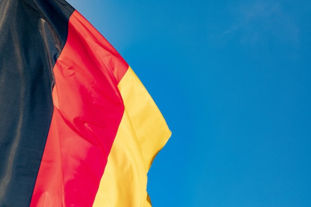 detail of german flag under clear blue sky