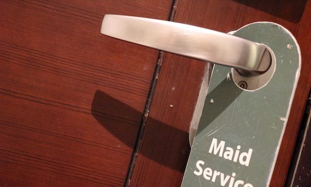 Modern hotel door handle with privacy please sign hanging
