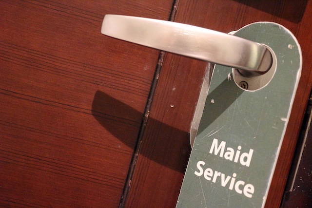 Modern hotel door handle with privacy please sign hanging