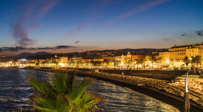 NICE, FRANCE - MARCH 2, 2026: Scenic twilight view of Promenade des Anglais with city lights, palm trees, and Mediterranean coastline.