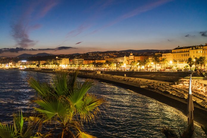 NICE, FRANCE - MARCH 2, 2026: Scenic twilight view of Promenade des Anglais with city lights, palm trees, and Mediterranean coastline.