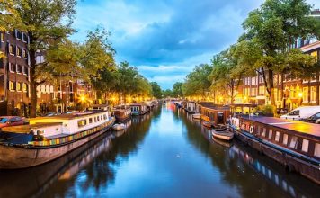Canals of Amsterdam at night. Amsterdam is the capital and most populous city of the Netherlands @ credit Depositphotos_62829165_XL