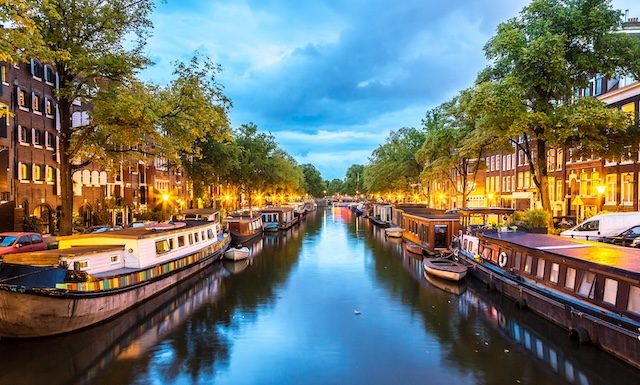 Canals of Amsterdam at night. Amsterdam is the capital and most populous city of the Netherlands @ credit Depositphotos_62829165_XL