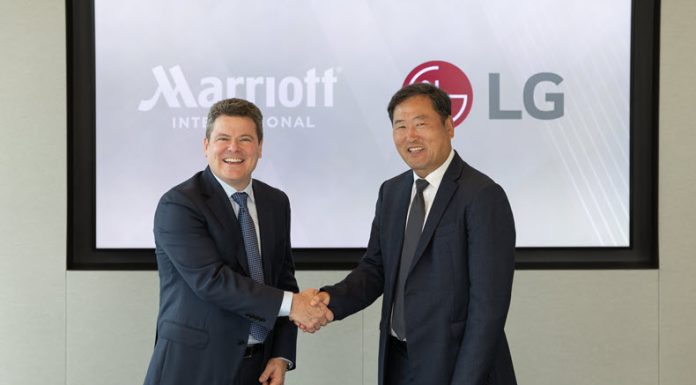 Drew Pinto, EVP and Chief Revenue and Technology Officer Marriott International and Don Kwack, President and CEO LG Electronics North America sign strategic agreement at Marriott International HQ