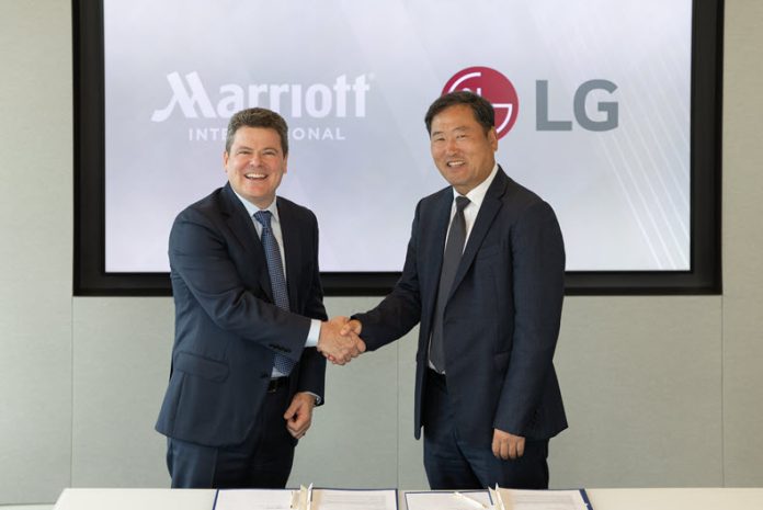 Drew Pinto, EVP and Chief Revenue and Technology Officer Marriott International and Don Kwack, President and CEO LG Electronics North America sign strategic agreement at Marriott International HQ