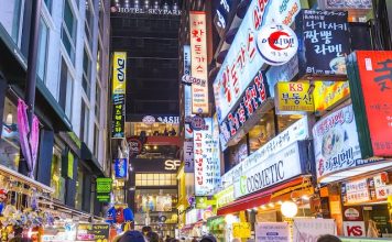 Illustration Myeong-Dong district at night. The location is the premiere district for shopping in the city @ credit Depositphotos.com