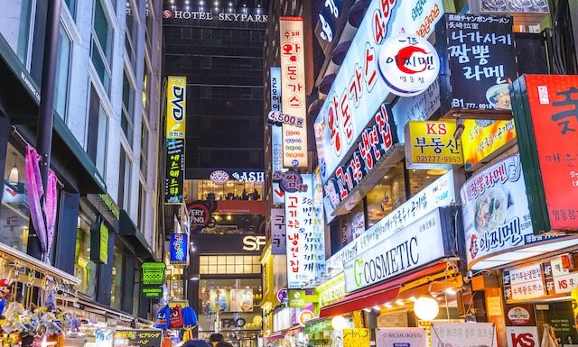 Illustration Myeong-Dong district at night. The location is the premiere district for shopping in the city @ credit Depositphotos.com